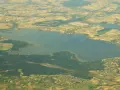 Jezioro Goczałkowickie z lotu ptaka. Widać jego rozległą taflę i otaczające pola uprawne. Głębokość jeziora jest trudna do oceny z tej perspektywy.